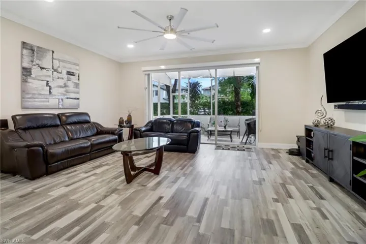 Living room featuring light wood-style floors and sliding glass door leading to the Lanai