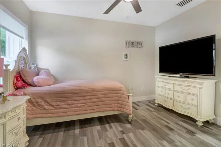 Bedroom with ceiling fan and hardwood / wood-style floors