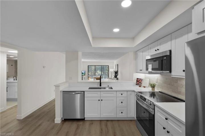Kitchen opens to living and dining area