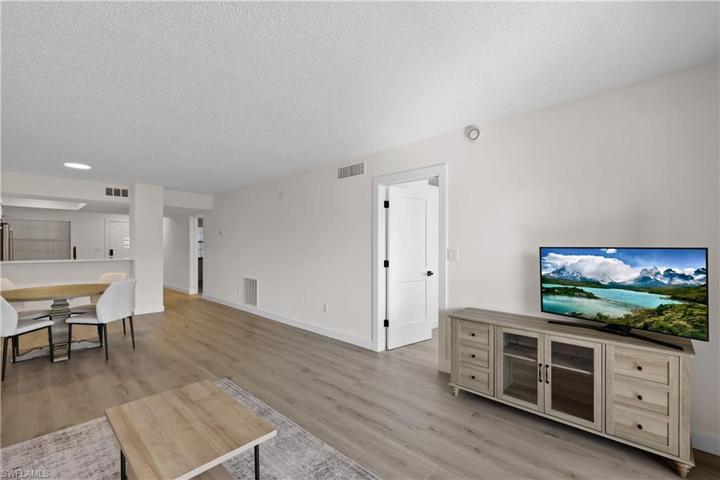 Living and dining area, entrance to primary bedroom