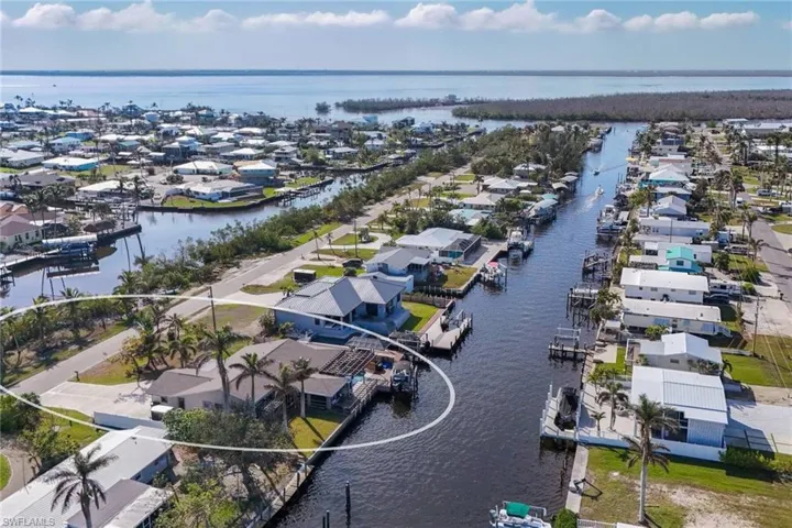 Birds eye view of property with a water view
