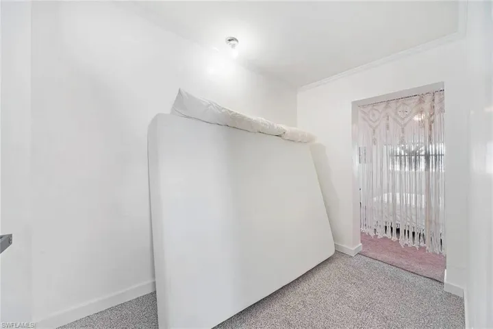 Walk in closet featuring light carpet