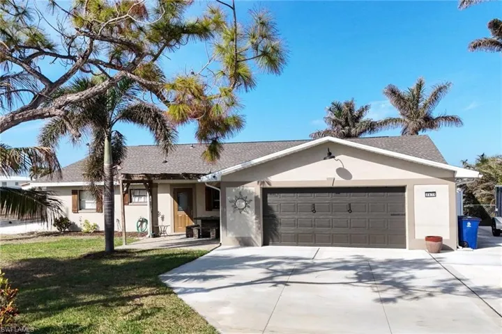 Ranch-style house with a garage and a front yard