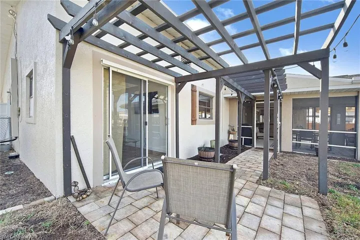 View of patio with a sunroom and a pergola