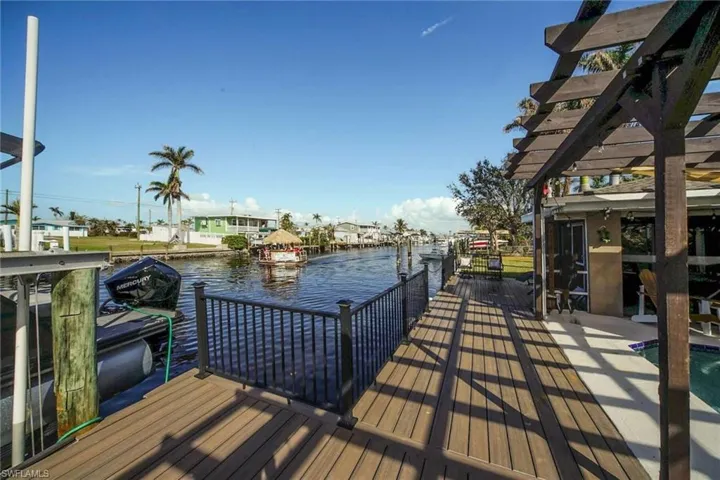 Dock area with a pergola and a water view