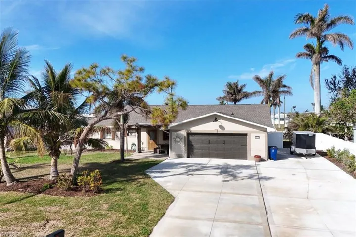 View of front of home featuring a front yard and a garage