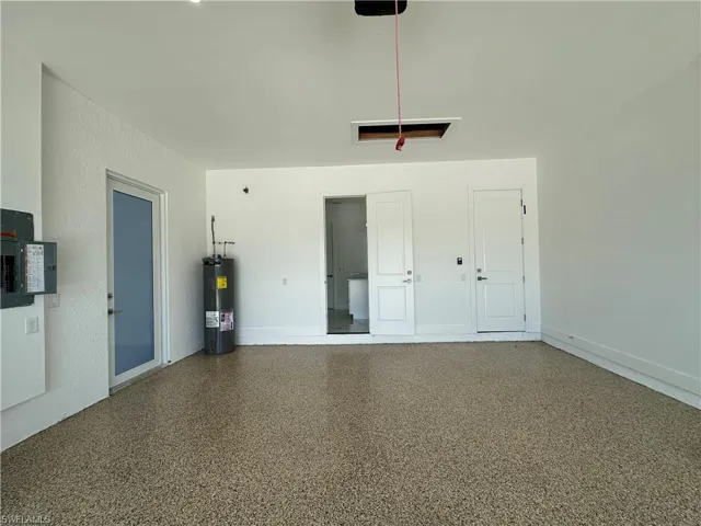 Garage with water heater and electric panel