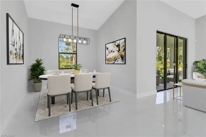 Dining space with baseboards, a notable chandelier, and plenty of natural light