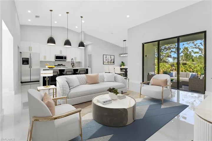 Living room with visible vents, high vaulted ceiling, and recessed lighting