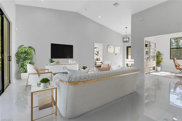 Living room featuring high vaulted ceiling and visible vents