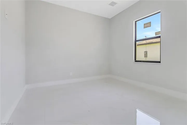 Empty room featuring visible vents and baseboards