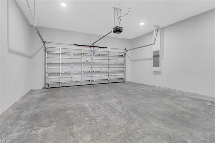 Garage with electric panel and a garage door opener