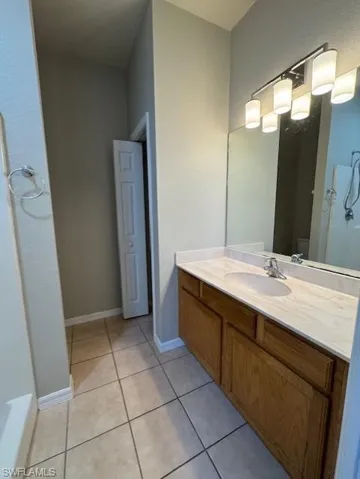Full bathroom featuring vanity and light tile patterned floors