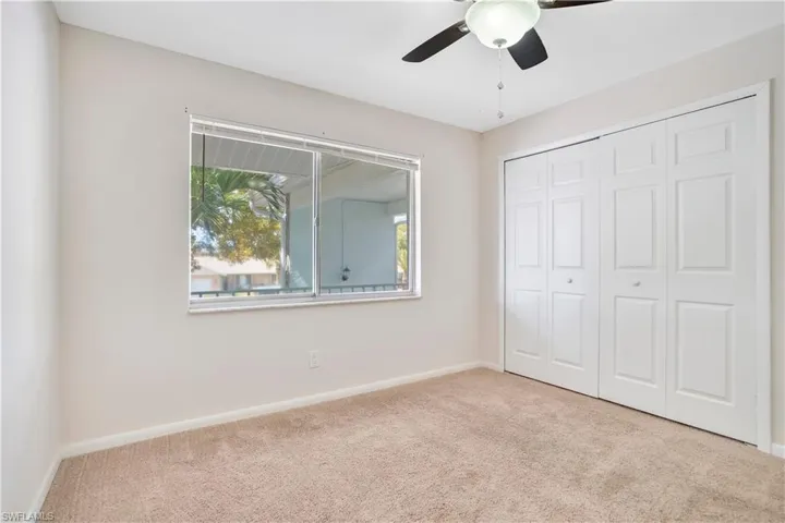 Unfurnished bedroom featuring carpet floors, a closet, and ceiling fan