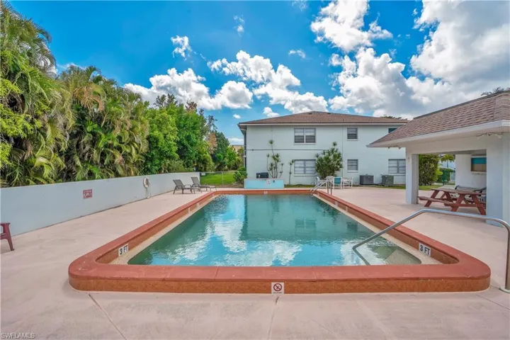 Community pool featuring a patio