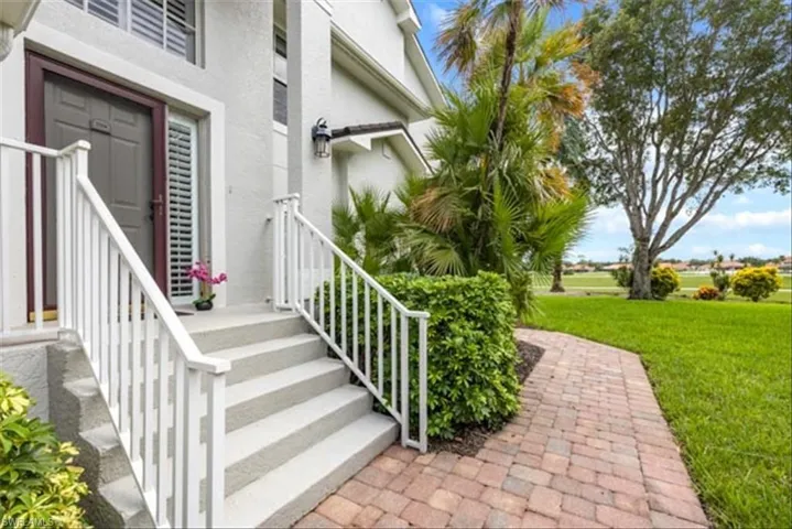 View of exterior entry featuring a yard