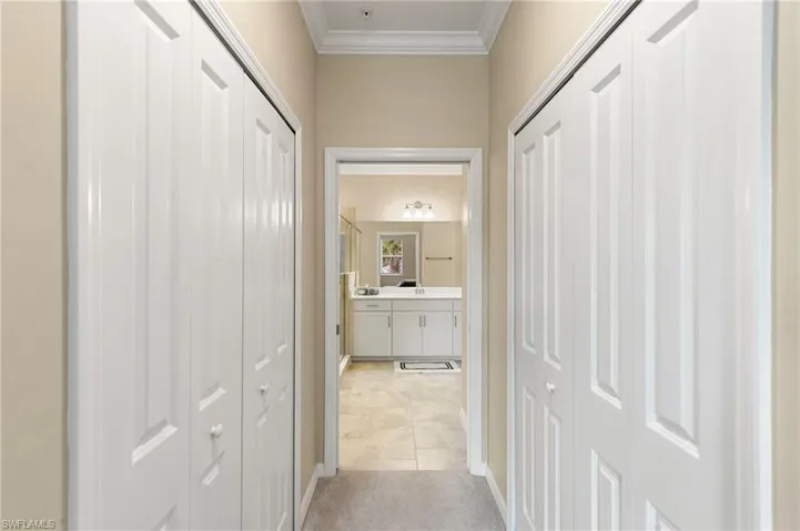 Hallway with light-colored walls and crown molding