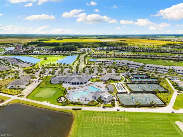 Expansive community featuring a central clubhouse, multiple swimming pools, and dedicated tennis courts