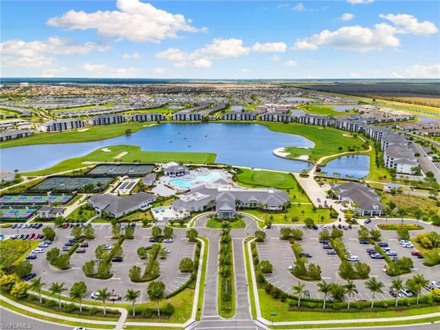 Expansive community grounds featuring a central lake, golf course, multiple tennis courts, and a large resort-style pool area