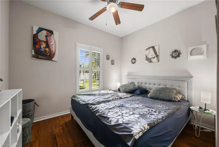 Bedroom with baseboards, wood finished floors, and ceiling fan