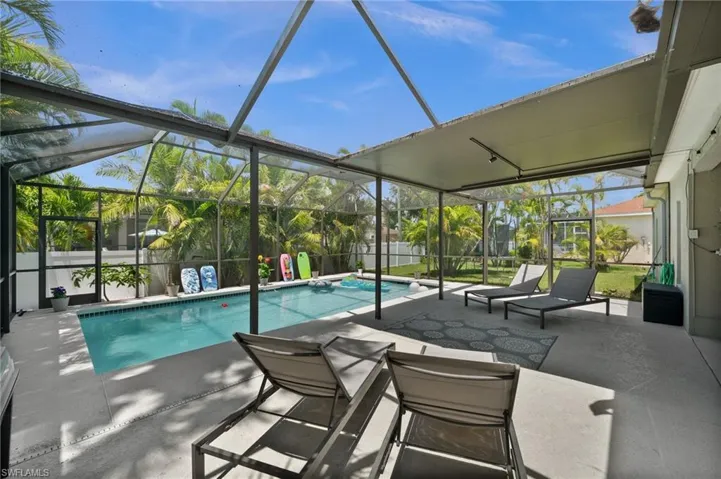 View of swimming pool with a lanai and a patio