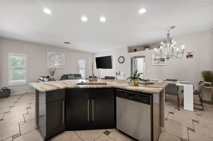 Kitchen with dishwasher, open floor plan, a chandelier, plenty of natural light, and recessed lighting