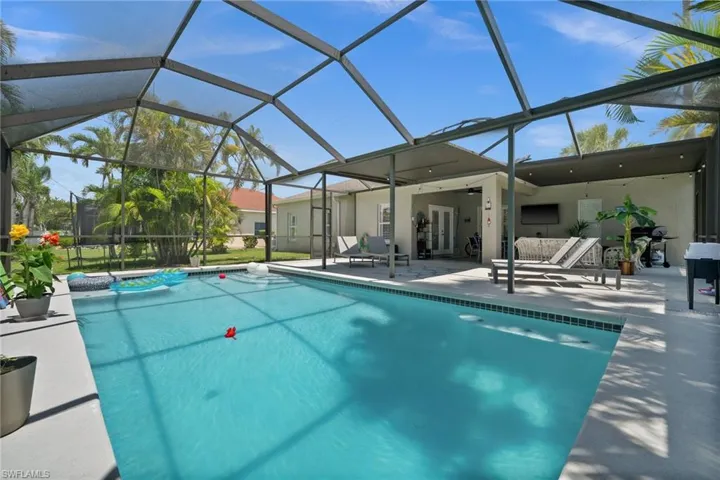 Swimming pool featuring a patio area, a lanai, and french doors