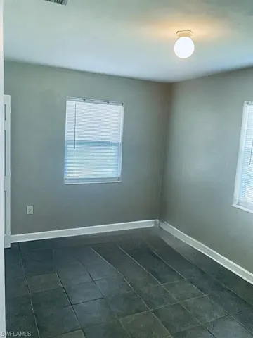 Spare room featuring baseboards
