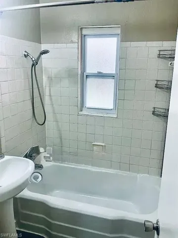 Bathroom featuring washtub / shower combination