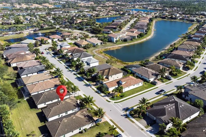 Aerial view of property's location with nearby suburban area and a large body of water