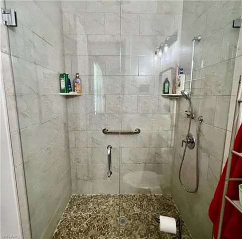 Bathroom featuring tiled shower and toilet