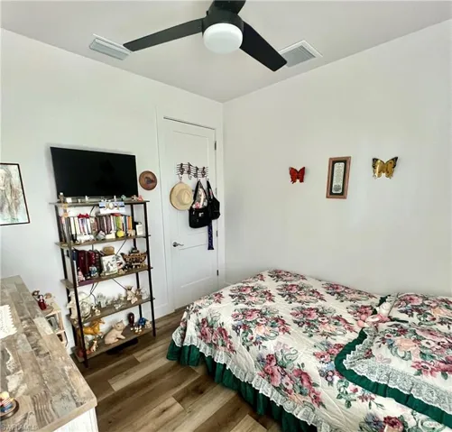 Bedroom featuring hardwood / wood-style flooring and ceiling fan
