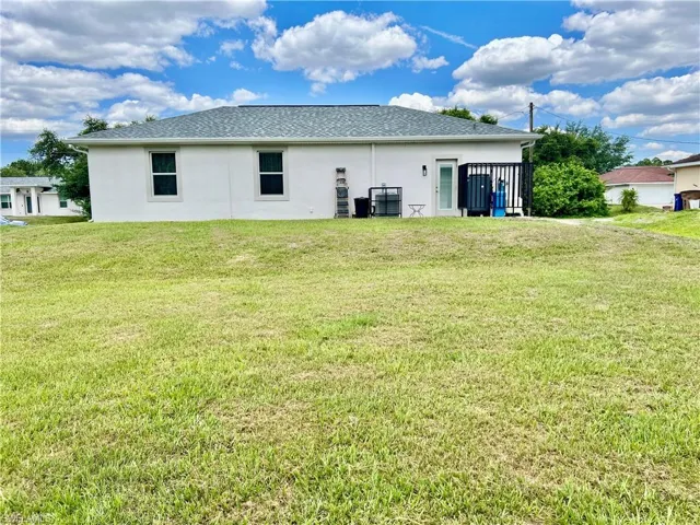 Back of house featuring a yard
