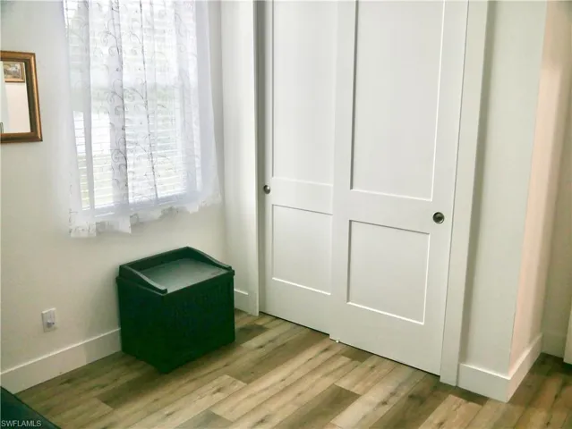 Unfurnished bedroom with hardwood / wood-style floors