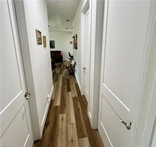 Hallway with hardwood / wood-style flooring