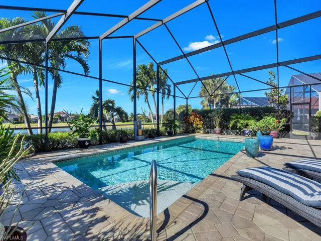 Outdoor pool featuring a patio and glass enclosure