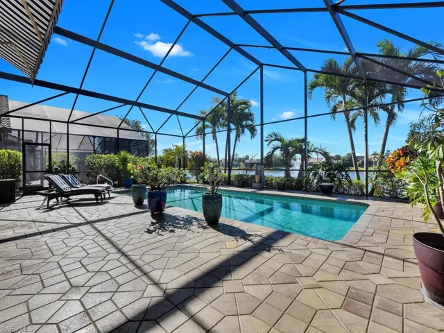 Outdoor pool with a patio and glass enclosure