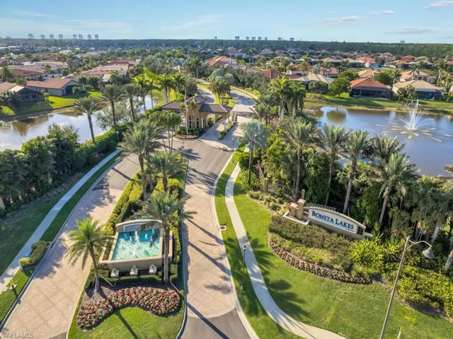 Aerial perspective of suburban area featuring a large body of water and skyline