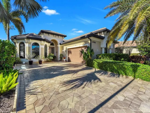 Mediterranean / spanish home featuring a garage, stucco siding, decorative driveway, and a tile roof