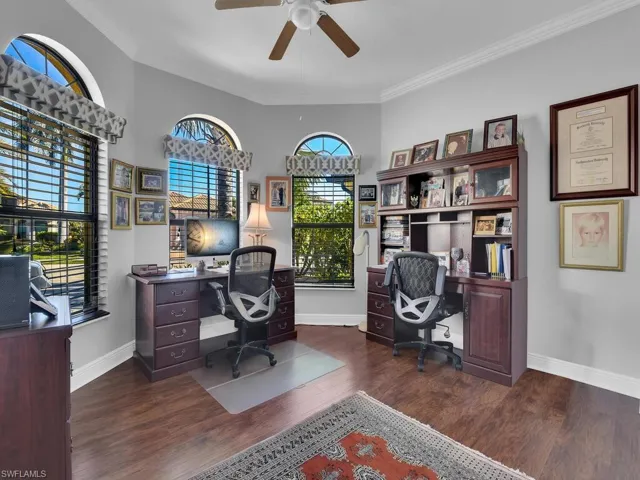 Office featuring a ceiling fan, ornamental molding, and wood finished floors