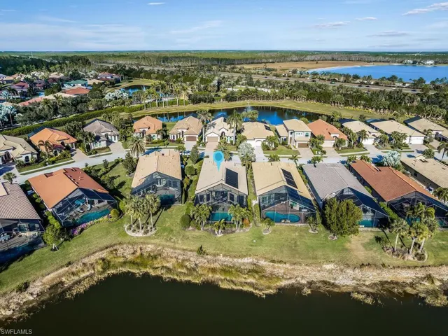 Aerial view of residential area featuring a large body of water