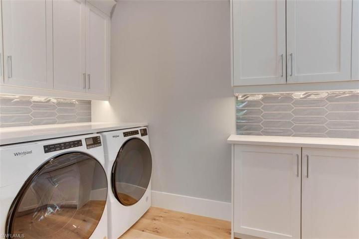 LAUNDRY ROOM: 42" UPPER CABINETS. TILT OUT LAURDRY HAMPER, PULL OUT WASTE BIN, UNDERCABINET LED LIGHTING