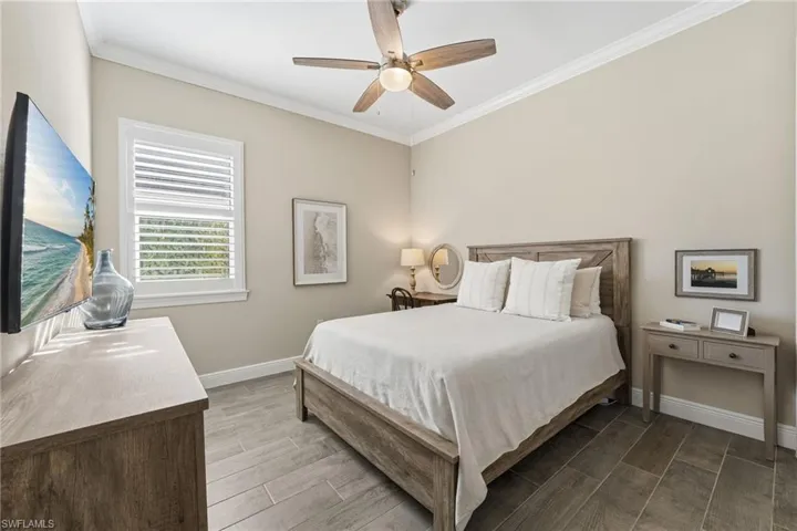 This generously sized second bedroom is filled with natural light, creating a warm and inviting retreat, and features its own private ensuite bath.