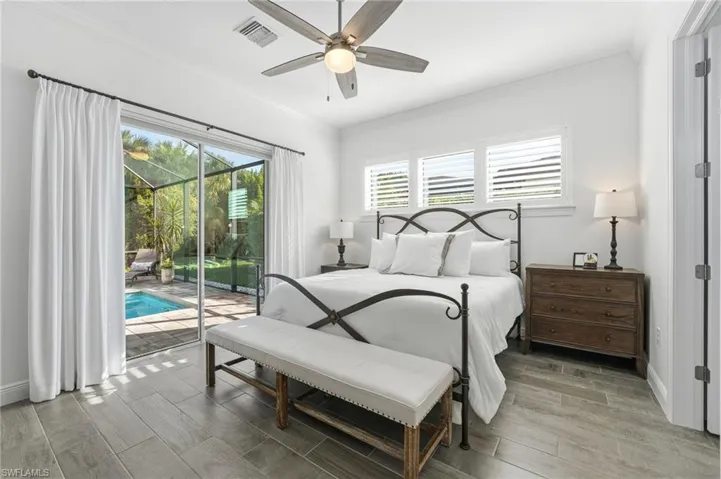 The primary ensuite features seamless access to the lanai, a generous walk-in closet, and an expansive bathroom, combining comfort, convenience, and luxury.
