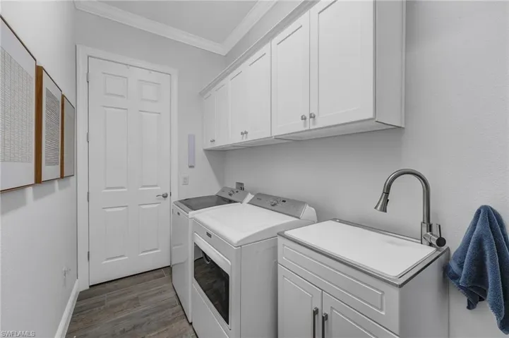 The spacious laundry room is equipped with a deep tub and abundant storage, combining practicality with style.