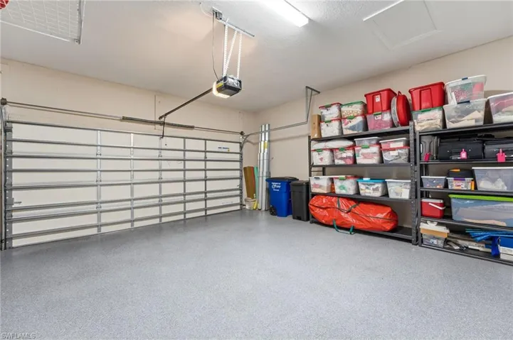 The spacious garage boasts a durable epoxy-finished floor and ample storage, providing both functionality and style.