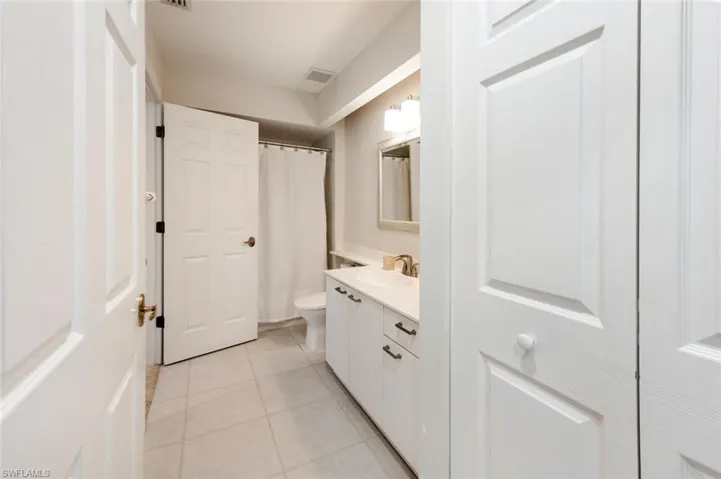 Bathroom with vanity, toilet, and tile patterned flooring