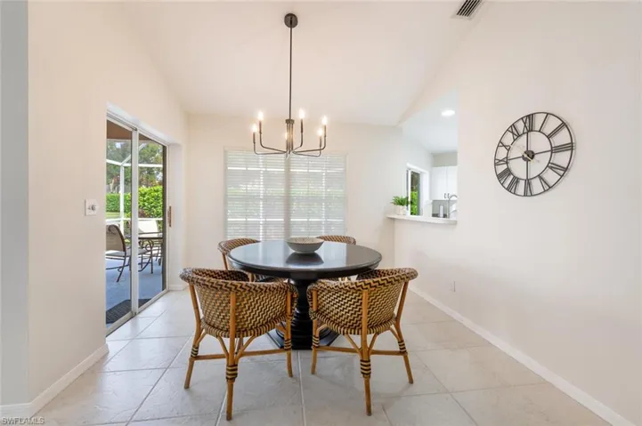 Dining room featuring vaulted ceiling and an inviting chandelier