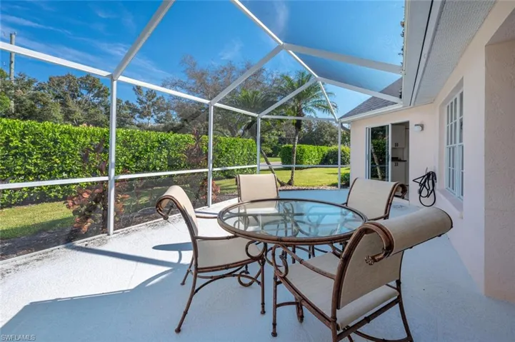 View of patio featuring glass enclosure