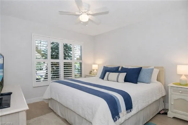 Bedroom with light wood-style floors and ceiling fan
